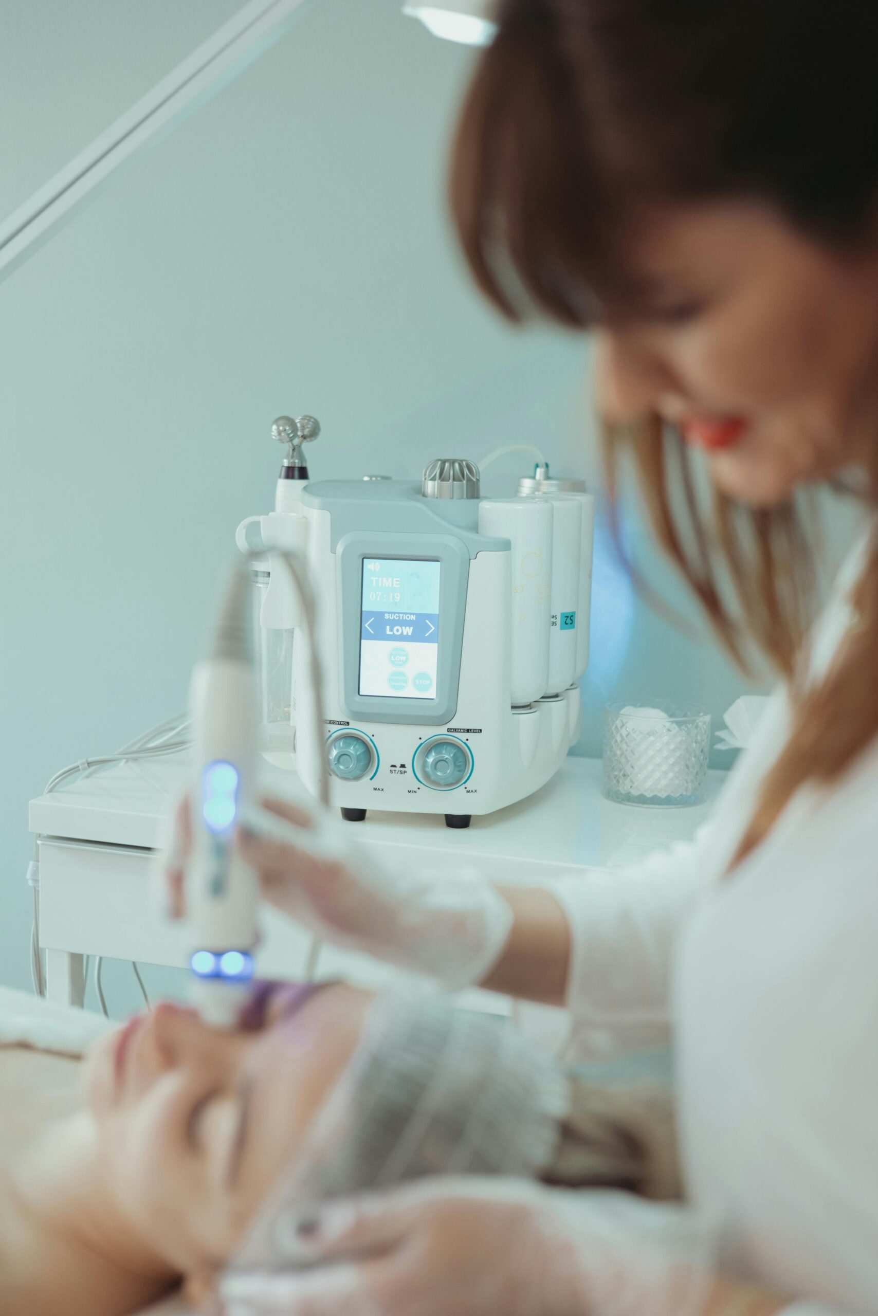 Close-up of a hydrafacial treatment being applied in a modern beauty clinic.
